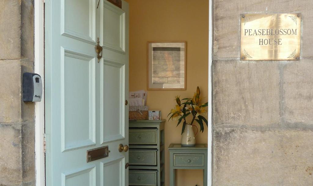 a door to a room with a dresser and a house at Peaseblossom House, a charming Grade II Listed Building, in a great location in Alnwick in Alnwick