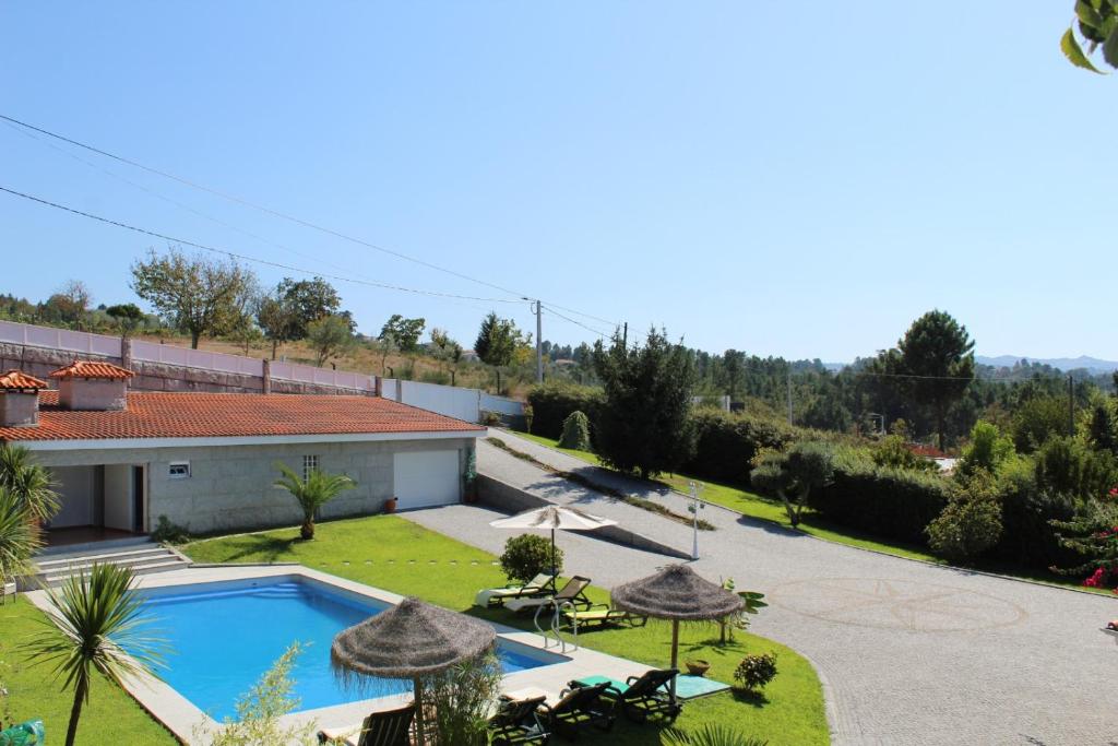 a villa with a swimming pool and a garden at Vivenda Marinho Wix in Porto