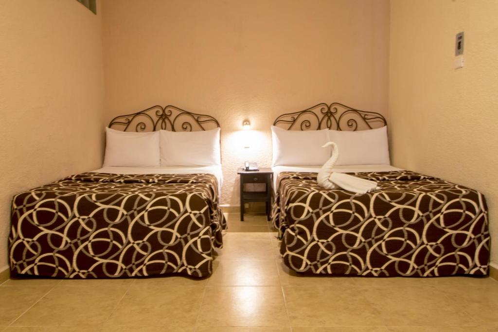 Postel nebo postele na pokoji v ubytování Hotel Colon Merida