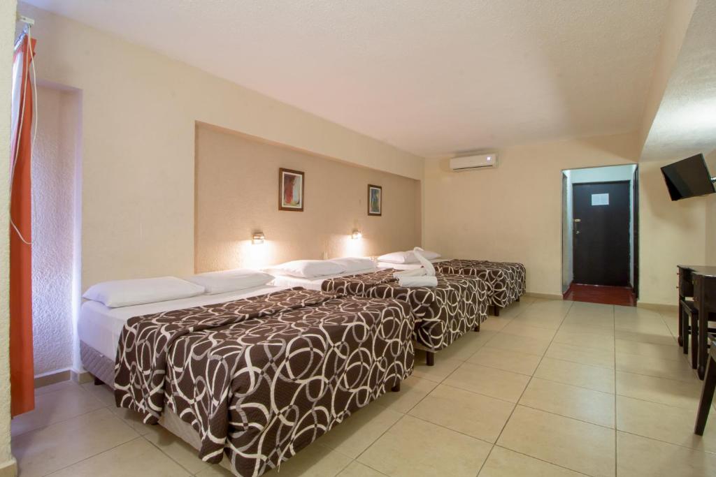 Postel nebo postele na pokoji v ubytování Hotel Colon Merida