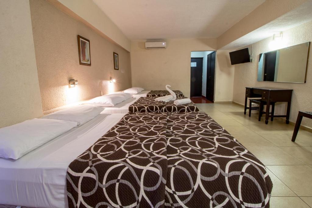 Postel nebo postele na pokoji v ubytování Hotel Colon Merida