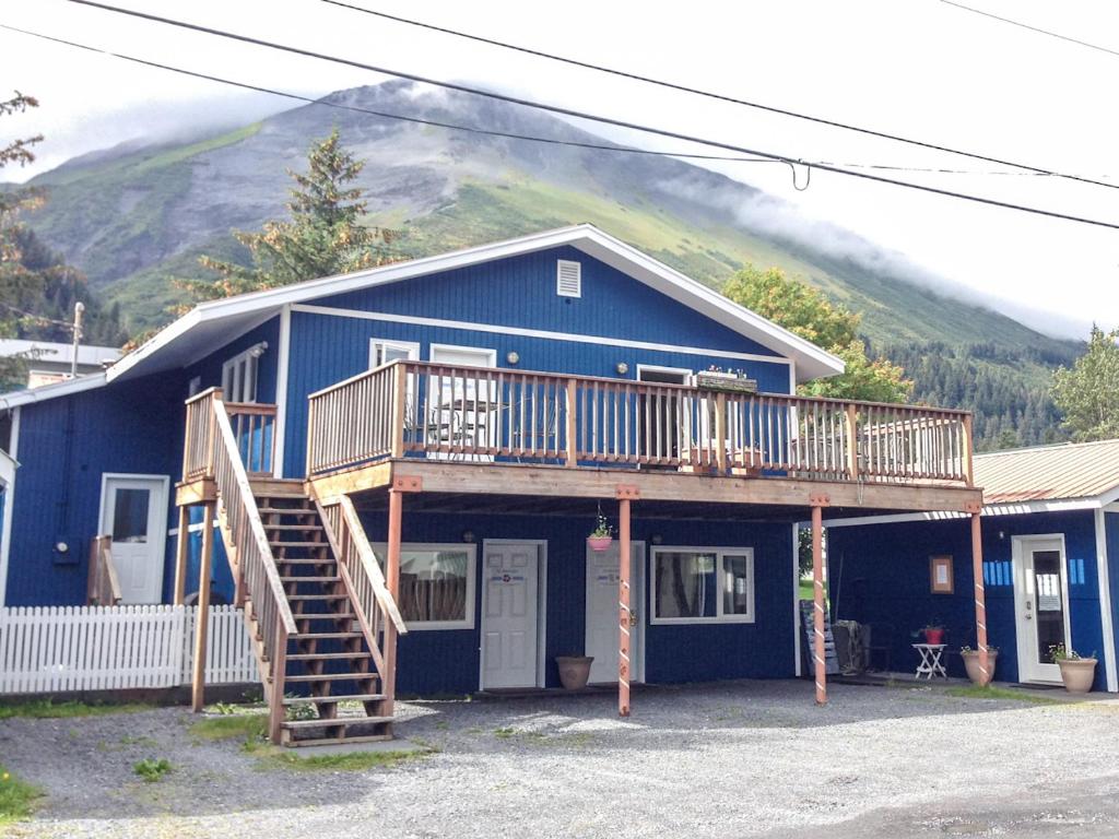 a blue house with a staircase in front of it at Sea Treasures Inn in Seward