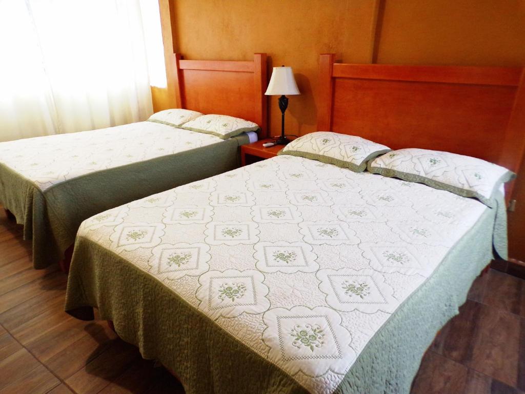 Tempat tidur dalam kamar di Posada "Inkali" Xilitla