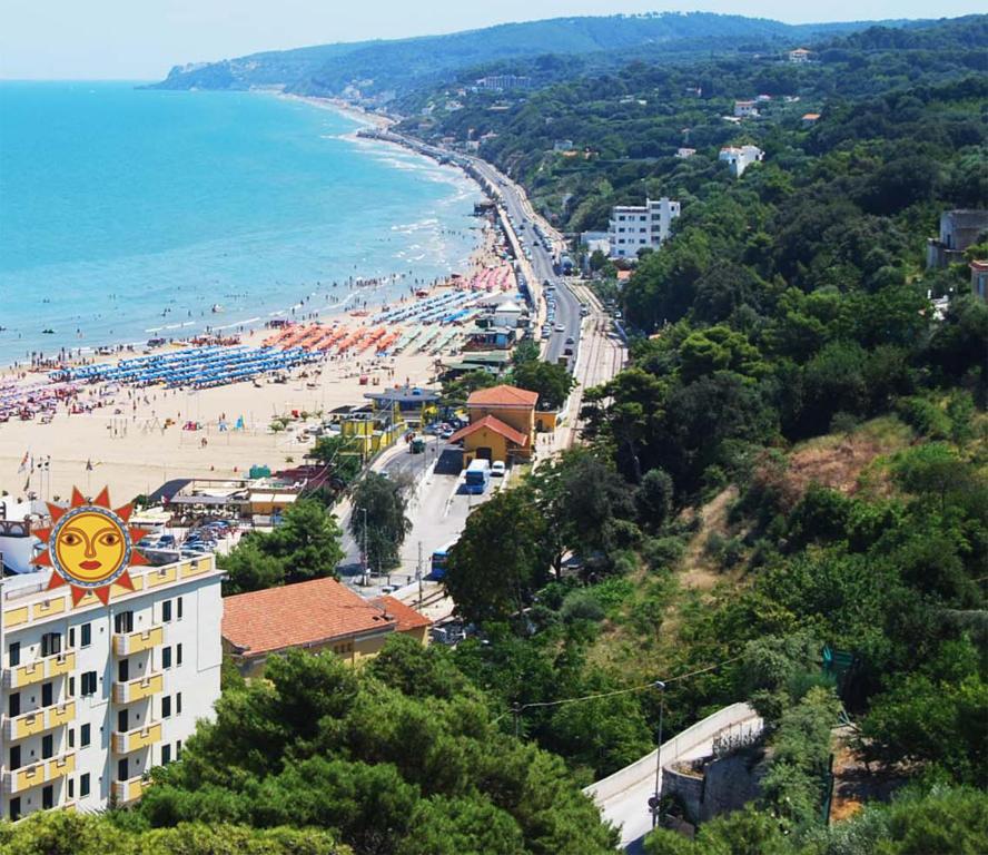 a view of a beach with a building and the ocean at Hotel Solaria in Rodi Garganico