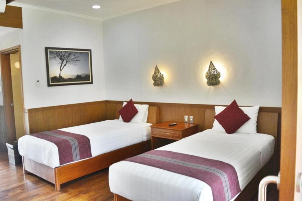 Postel nebo postele na pokoji v ubytování Manohara Resort