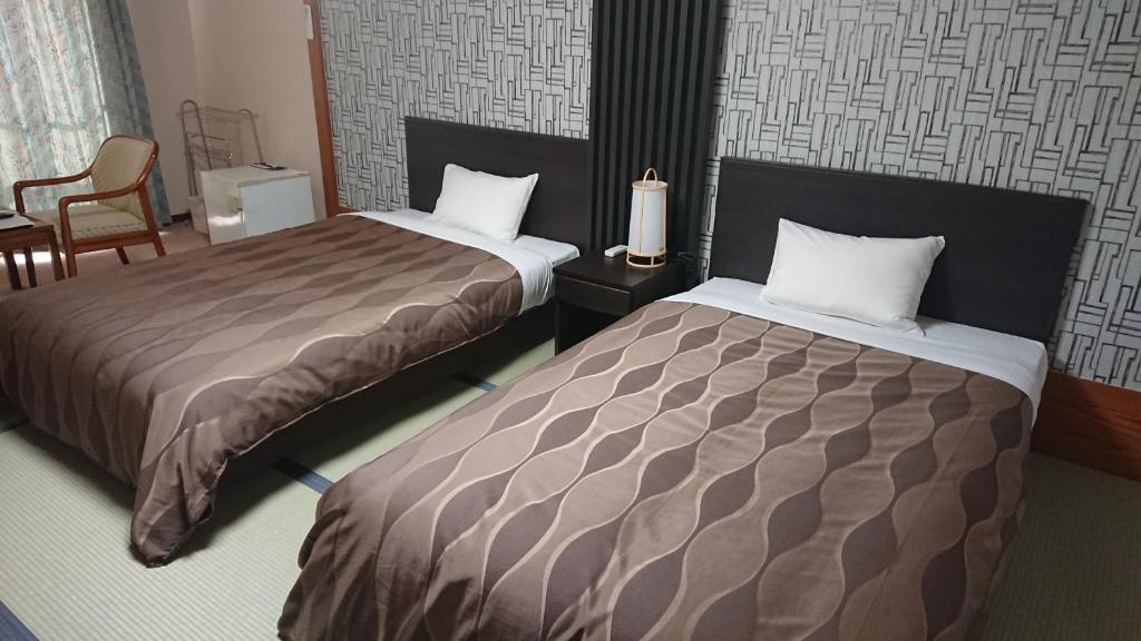 Postel nebo postele na pokoji v ubytování The Gran Resort Elegante Atami