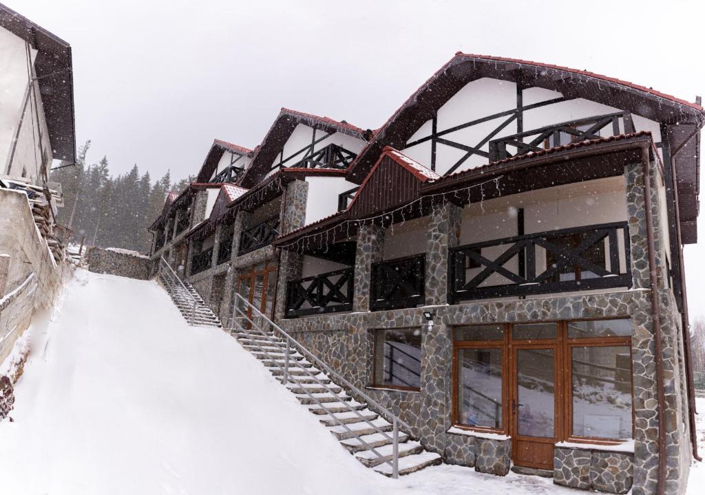 a building covered in snow in the snow at Brand NEW 2020 specious apartments DRUZI 3 in Bukovel