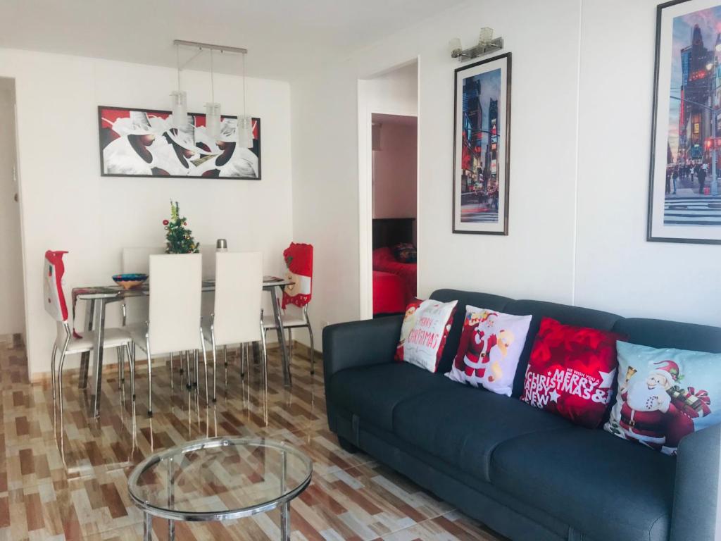 a living room with a blue couch and a table at Cosmopolita Rojo in La Serena