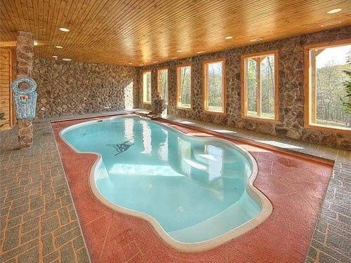 a large swimming pool in a house with a largeiameter at Majestic Springs Lodge Cabin in McCookville
