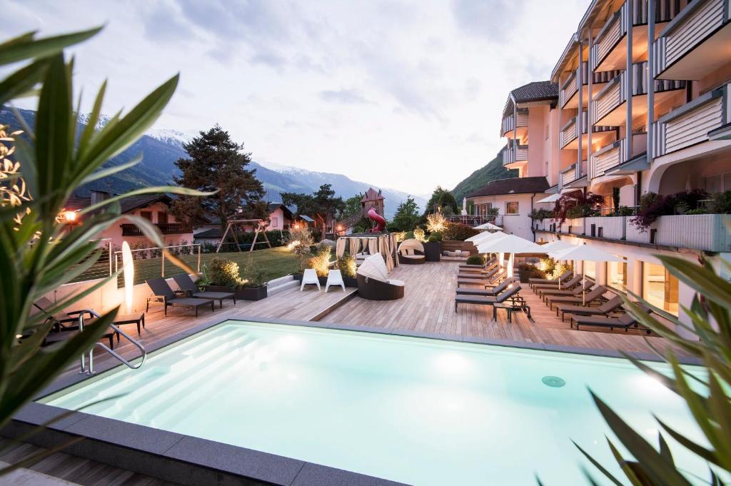 un hotel con piscina en un balcón con montañas en Heidi & Edith Family Aparthotel, en Rablà