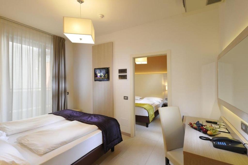 Postel nebo postele na pokoji v ubytování Hotel Lido Bibione Beach