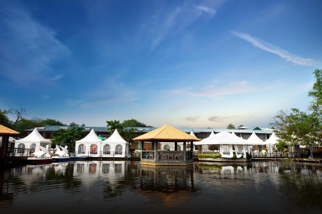 a group of white tents on a body of water at Ramadia Ran Mal Holiday Resort in Moratuwa