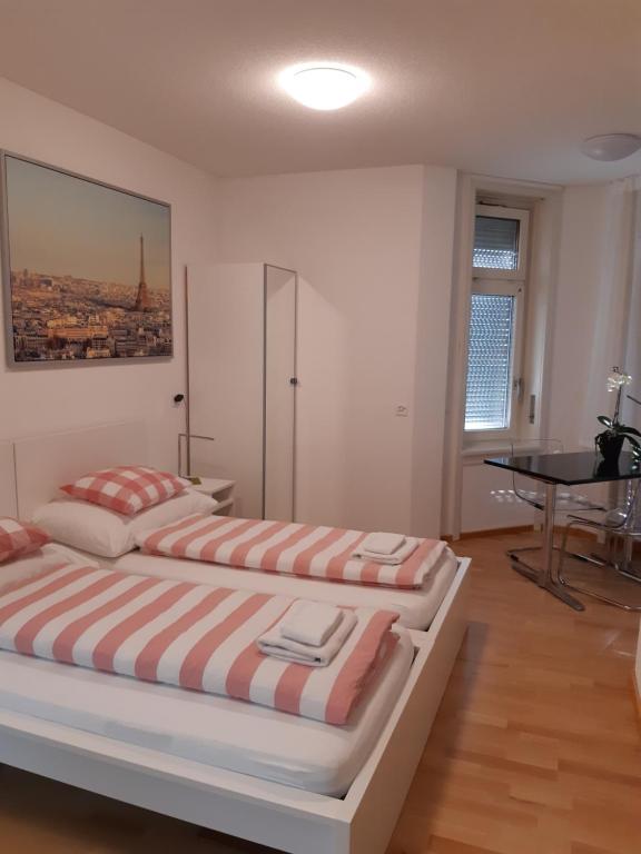 a bedroom with two beds and a piano in it at Good Bed Reiden in Reiden