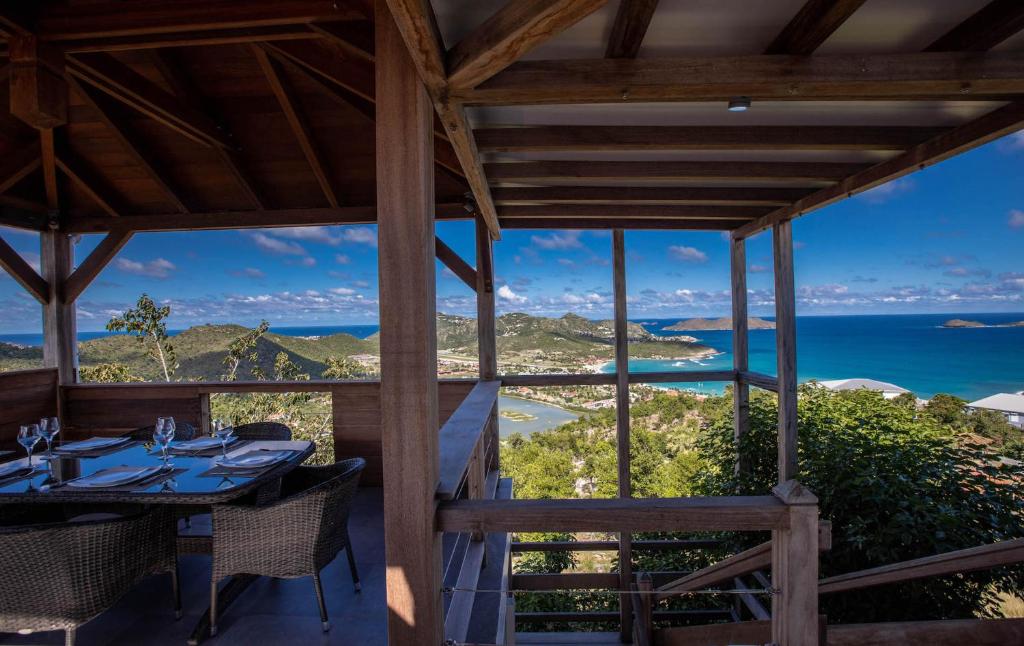 a dining room with a view of the ocean at Dream Villa St-Jean 602 in Saint Barthelemy