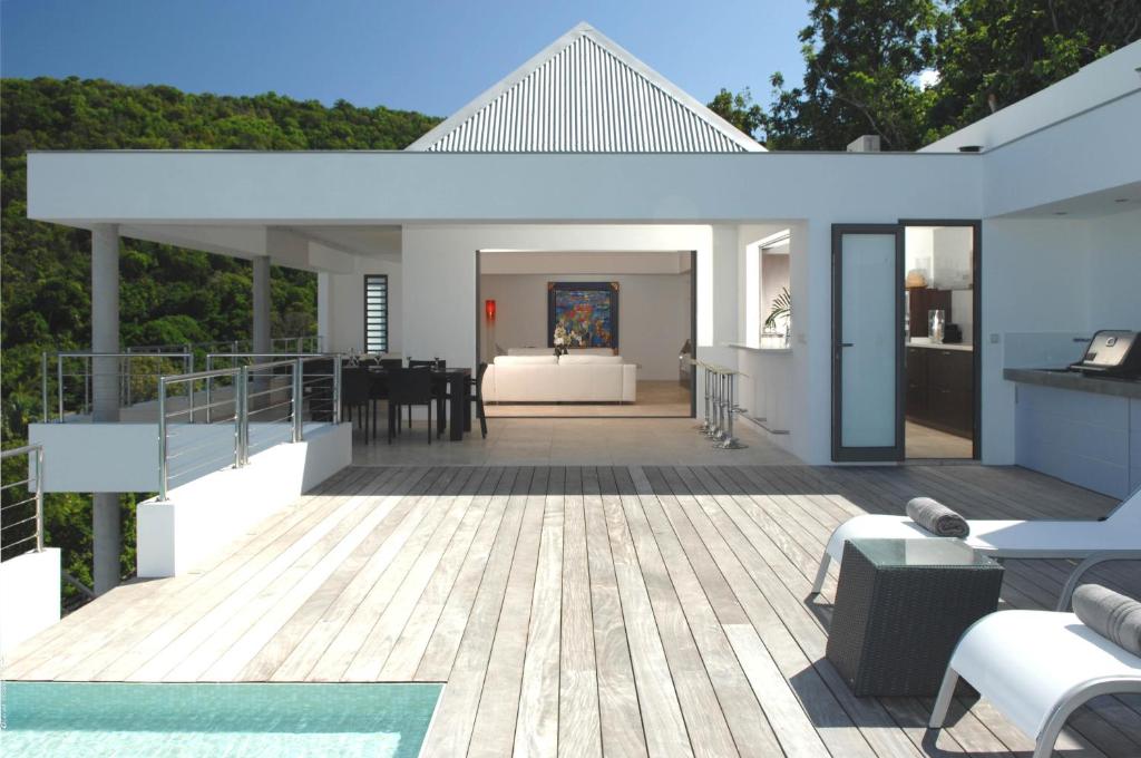 a house with a deck with a living room at Dream Villa Flamands 606 in Anse des Cayes