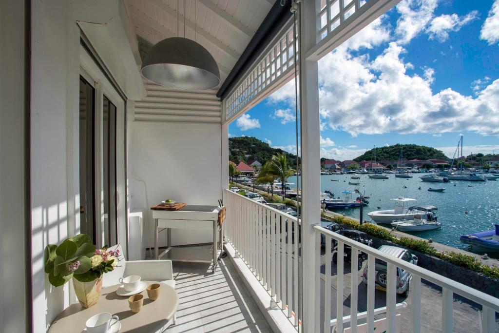 a balcony with a view of the water and boats at Dream Villa Gustavia 868 in Gustavia