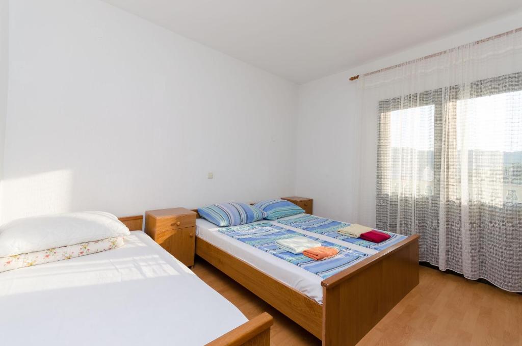 Postel nebo postele na pokoji v ubytování Apartments Boza