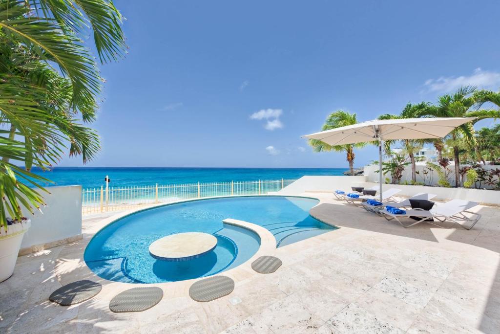 a swimming pool with a view of the ocean at Dream Villa Shore Point 553 in Lowlands