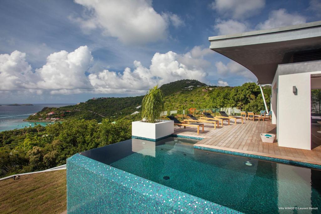 a house with a swimming pool with a view of the ocean at Dream Villa St Jean 891 in Saint Barthelemy