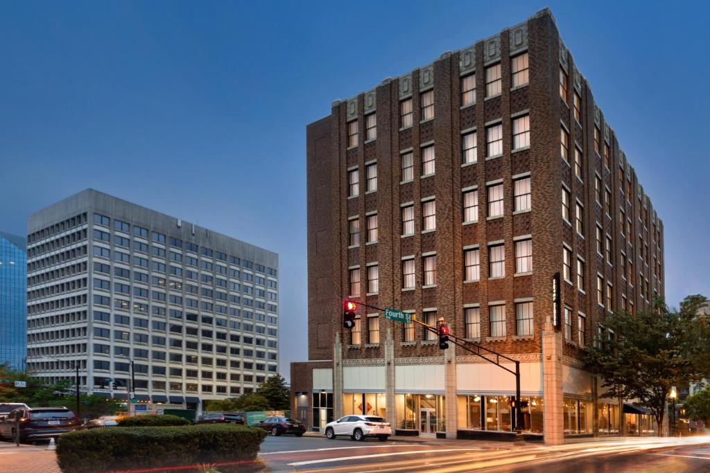 a tall building on a city street with a traffic light at Hotel Indigo - Winston-Salem Downtown by IHG in Winston-Salem
