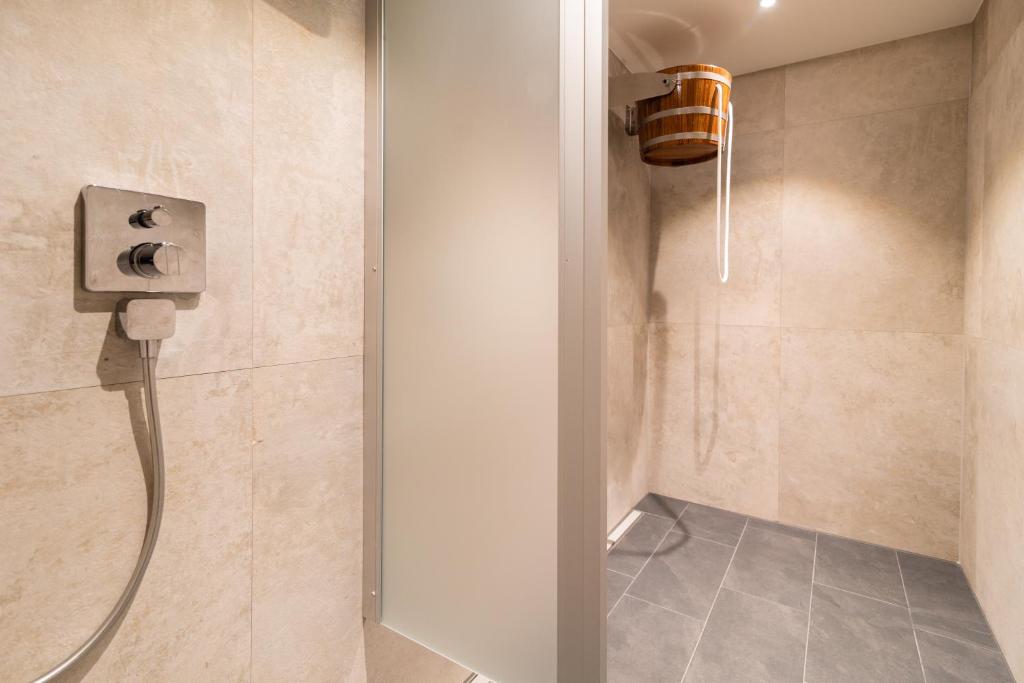 a shower with a shower head in a bathroom at Hotel & Gasthof Richard Held in Regensburg
