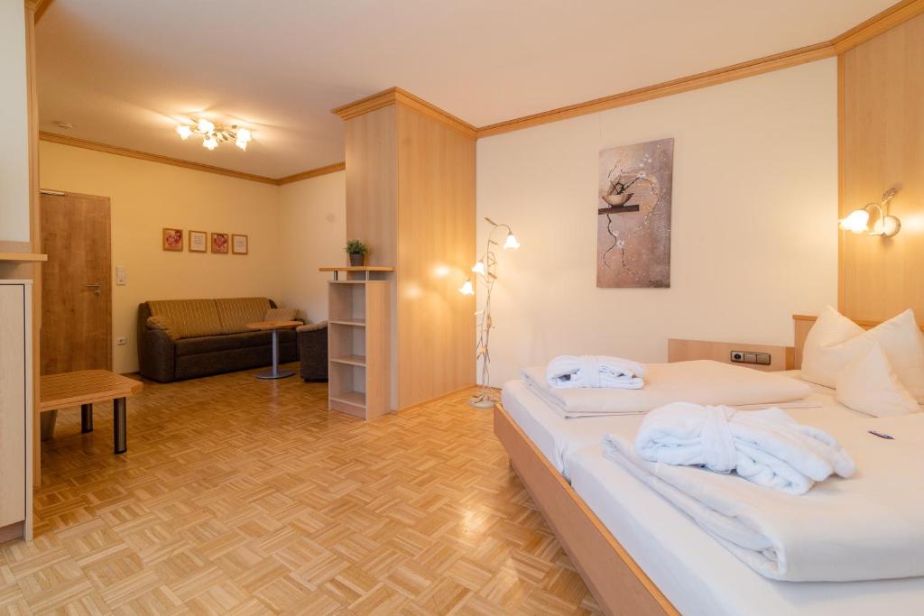 a hotel room with a bed and a couch at Hotel & Gasthof Richard Held in Regensburg