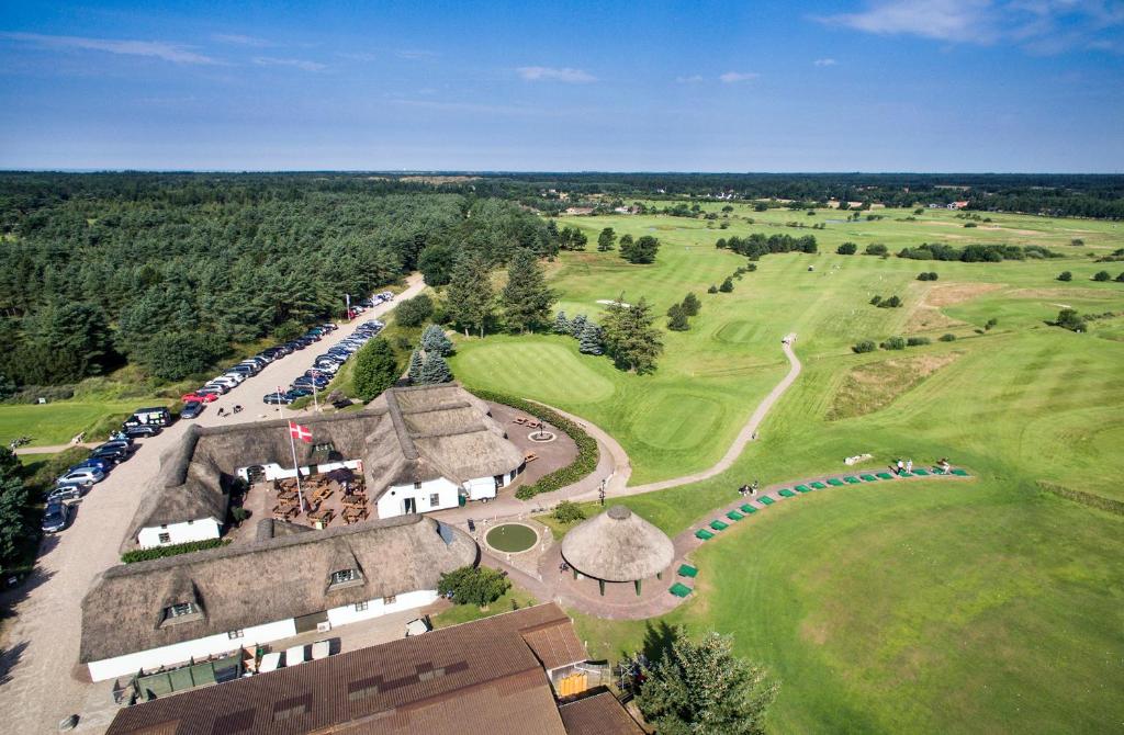 an aerial view of a building with a golf course at Blåvandshuk Golf Hostel in Blåvand