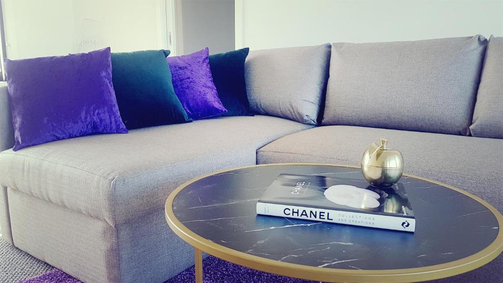 a living room with a couch and a glass table at Tranquility in Lakes Entrance