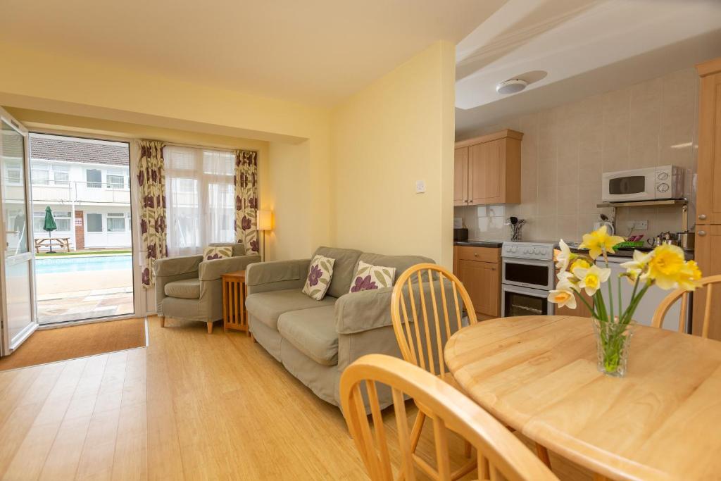 a living room with a couch and a table at Del Mar Court in St Martin Guernsey