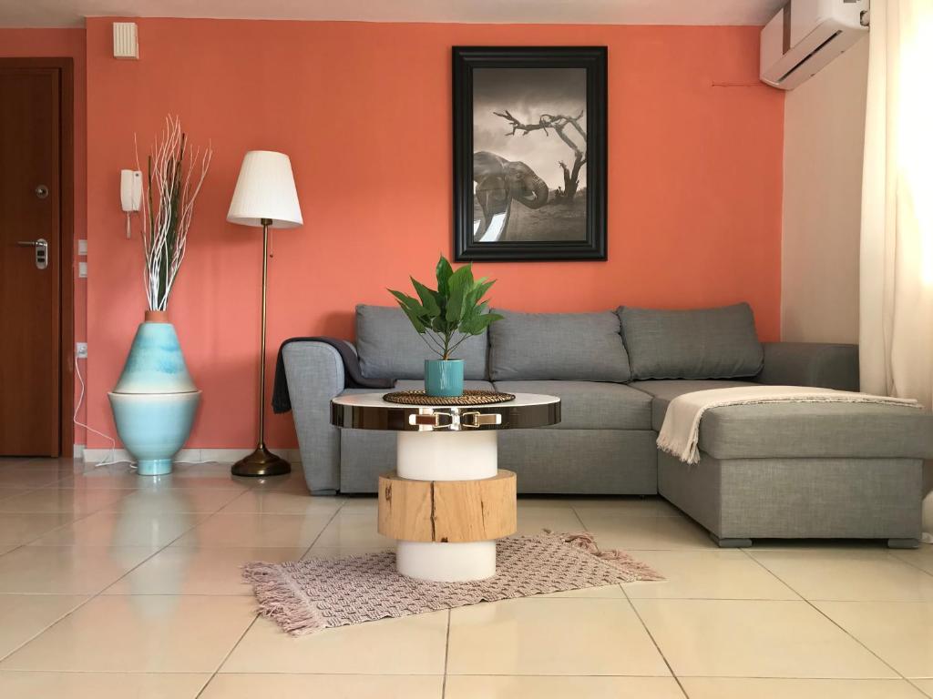 a living room with a couch and a table at Irini Apartments in Kavála