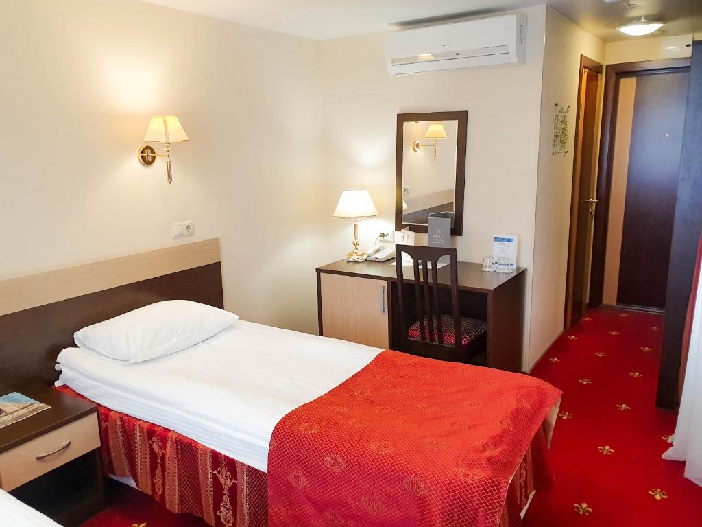 Postel nebo postele na pokoji v ubytování AMAKS Safar Hotel