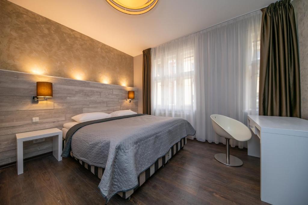 a hotel room with a bed and a window at Emporio Prague Apartments in Prague