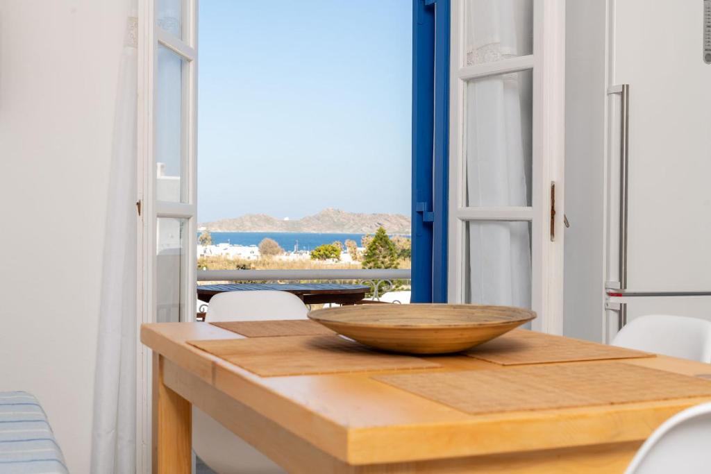 a wooden table with a bowl on top of it at VILLA KOSTA in Naousa-Paros in Naousa