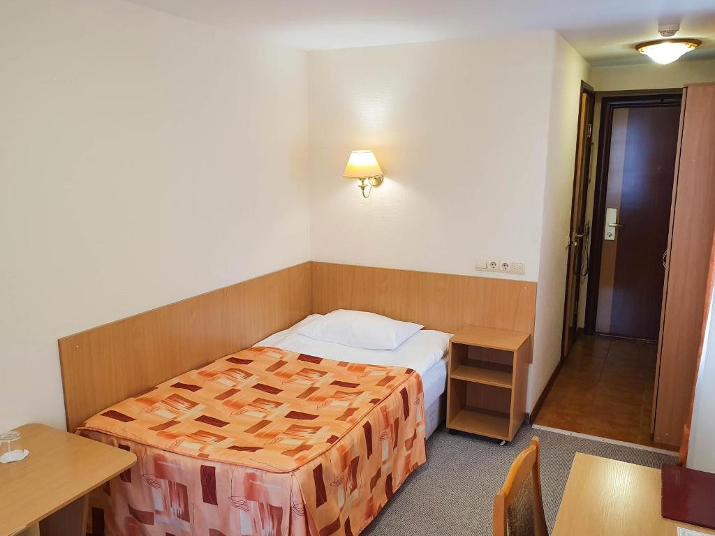 Postel nebo postele na pokoji v ubytování AMAKS Safar Hotel