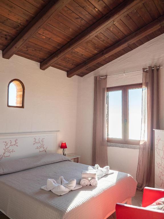 A bed or beds in a room at Il Tramonto Tanca Piras