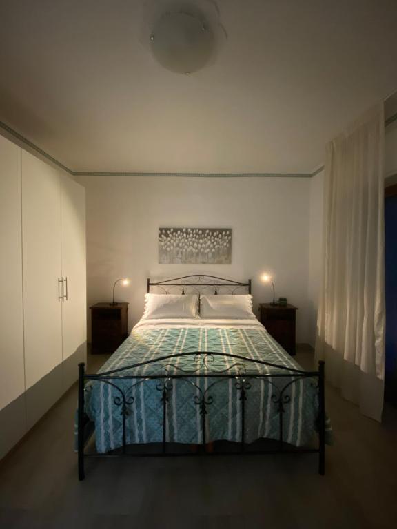 a bedroom with a bed with a blue comforter at Casa di Chiara in Polignano a Mare