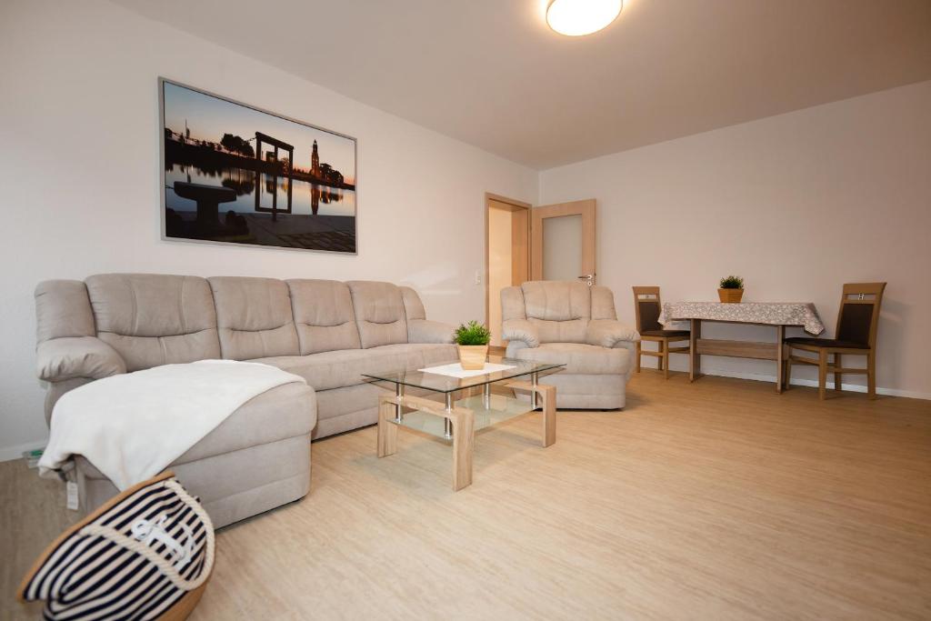 a living room with a couch and a table at FeWo Batteriestraße in Bremerhaven