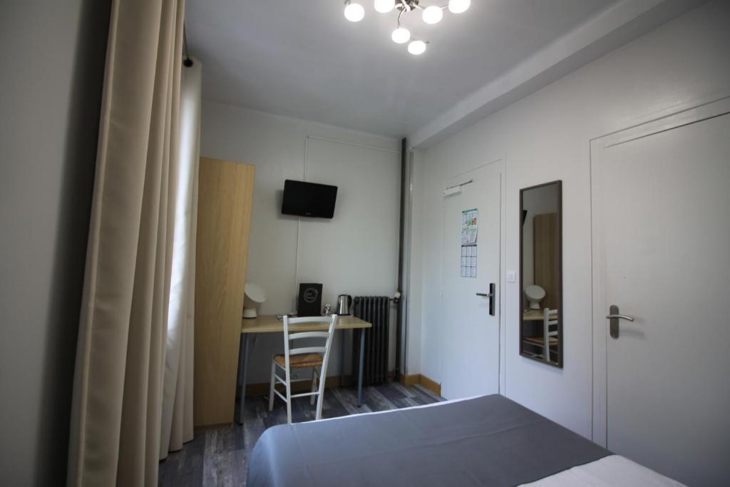 Postel nebo postele na pokoji v ubytování Hotel De l'Univers