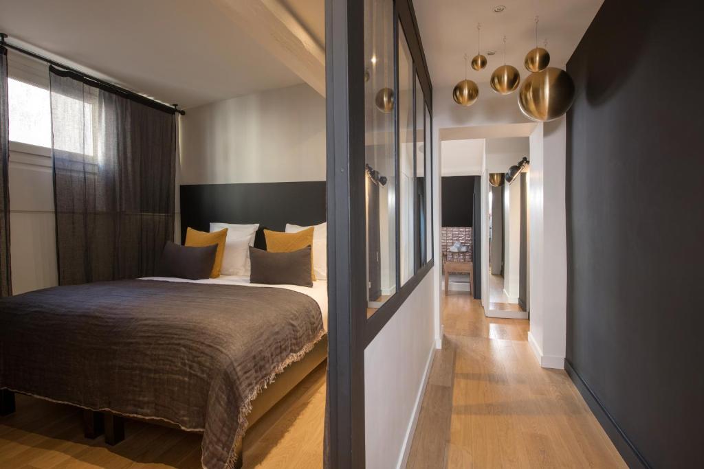 Postel nebo postele na pokoji v ubytování MiHotel Gailleton