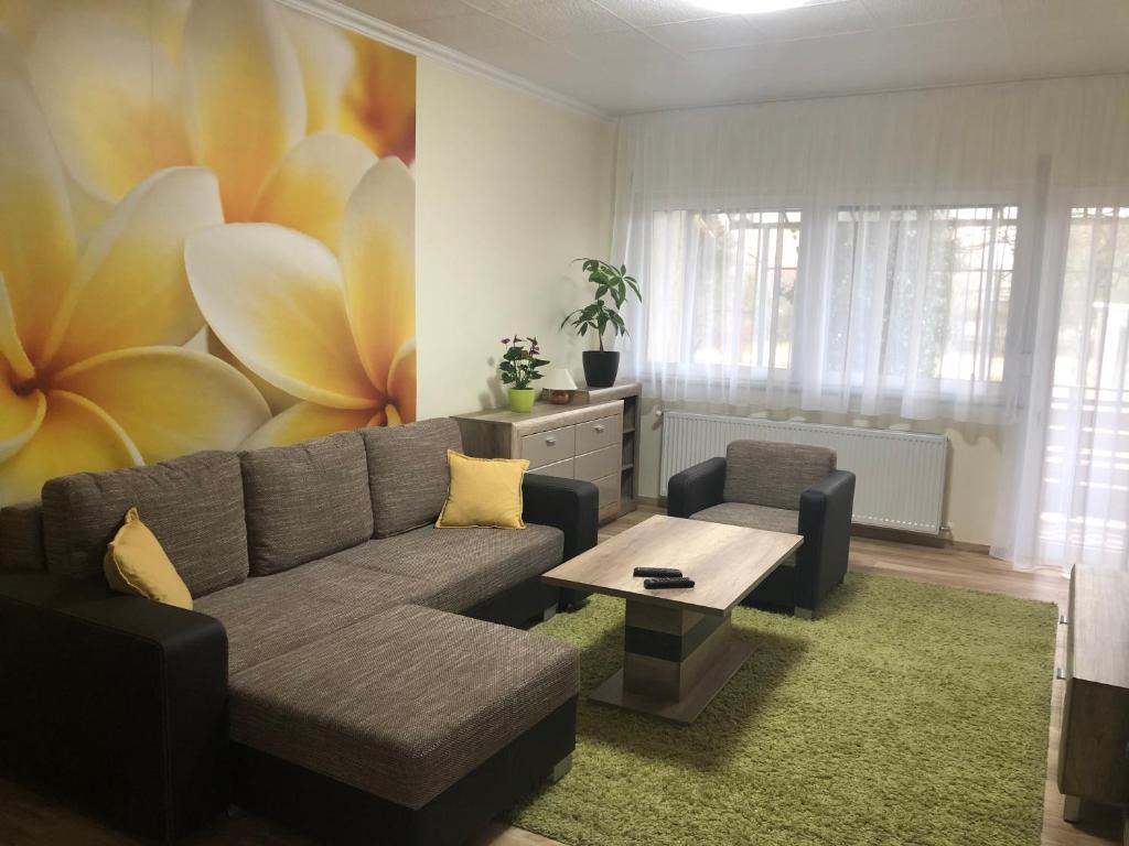 a living room with a couch and a table at Galéria deluxe apartman in Mezőkövesd
