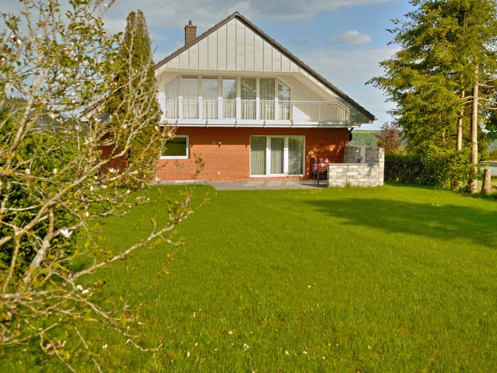 a house with a green lawn in front of it at Apartment Belvedere by Interhome in Manderscheid