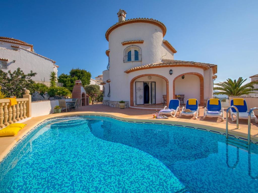a swimming pool in front of a villa at Villa Robinson by Interhome in Pedreguer