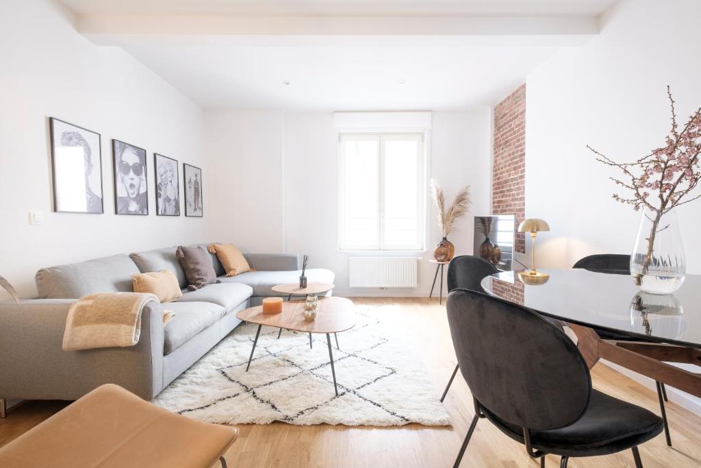 a living room with a couch and a table at The Doms Flats in Brussels