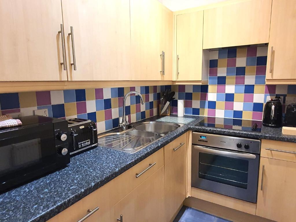 Kuchyň nebo kuchyňský kout v ubytování Summerhill Apartments
