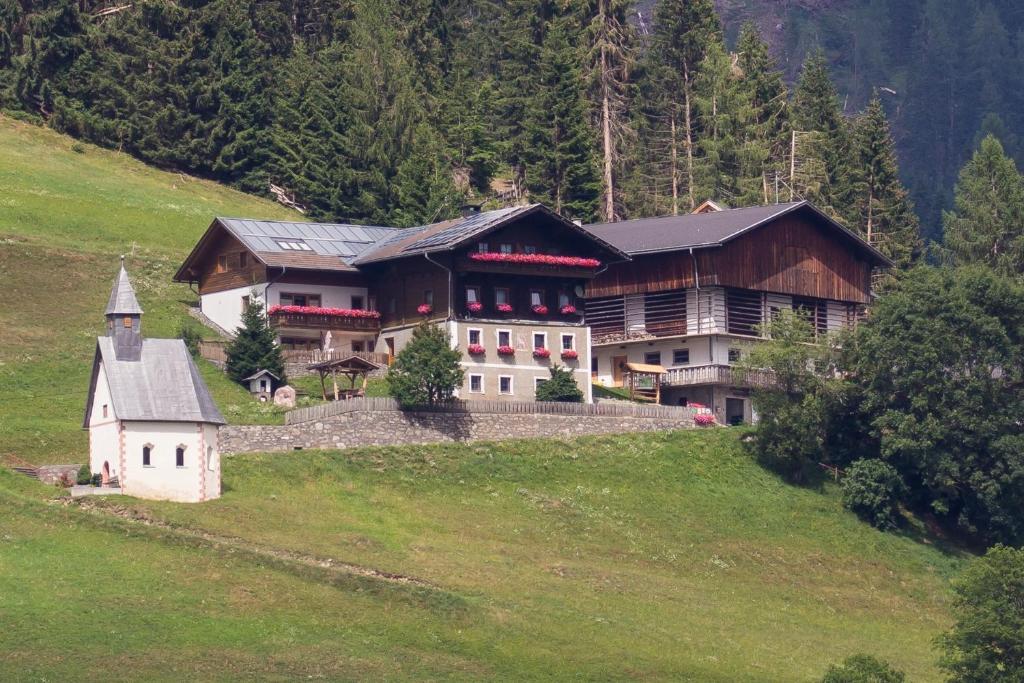 una casa grande en una colina en un campo en Jörgishof, en Untertscheltsch