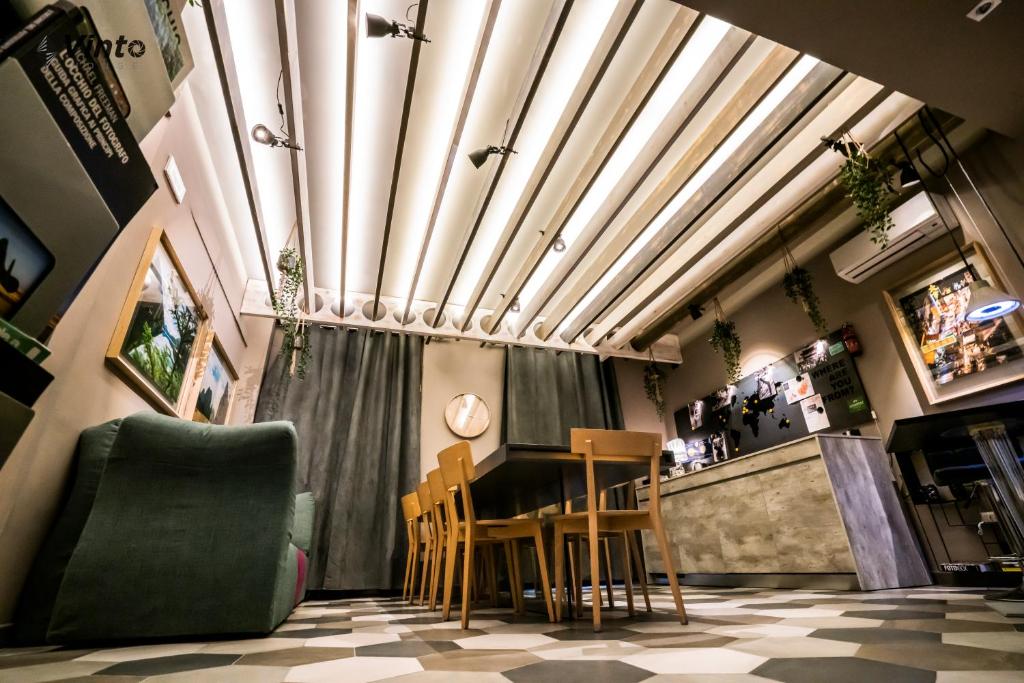 a restaurant with a table and chairs in a room at Vinto House Salerno Downtown in Salerno