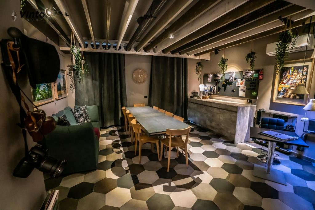 a dining room with a table and chairs and a counter at Vinto House Salerno Downtown in Salerno