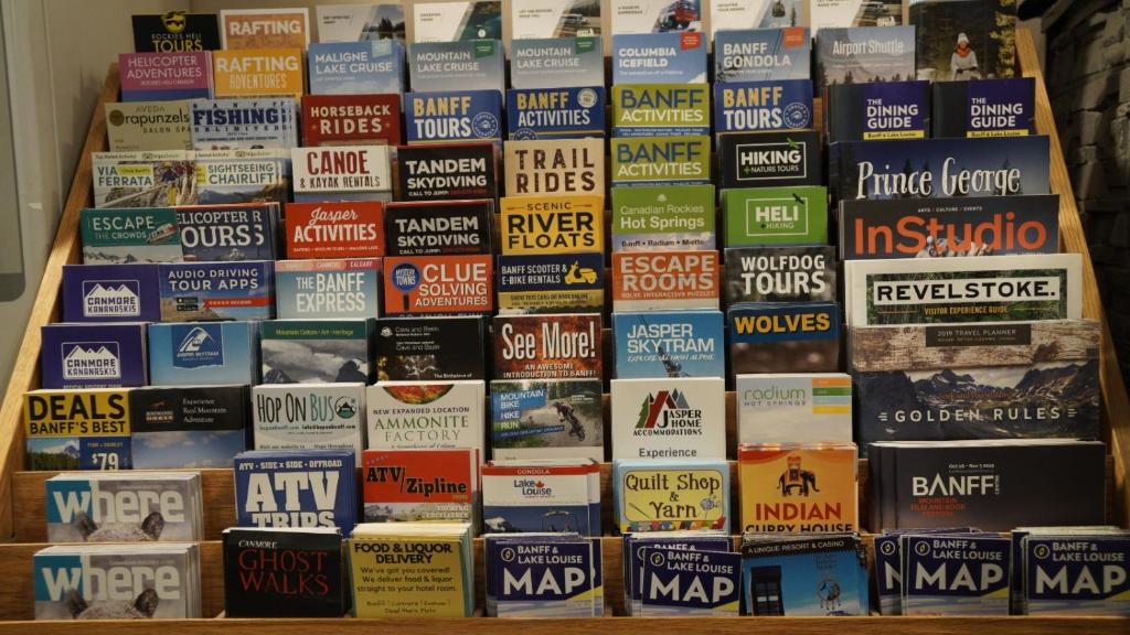 a bunch of books stacked on top of each other at Banff International Hostel in Banff