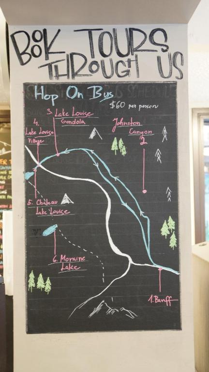a chalkboard with a hiking map on a wall at Banff International Hostel in Banff