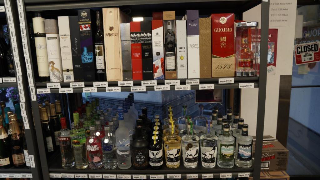 a shelf filled with lots of bottles of alcohol at Banff International Hostel in Banff